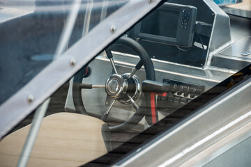 Fototapeta premium Steering wheel in the cockpit of a motor yacht, close-up