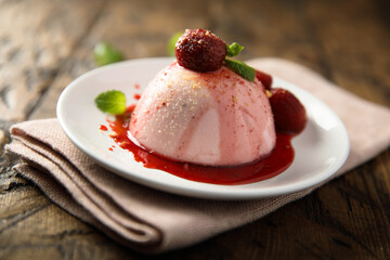 Homemade strawberry panna cotta with berry sauce
