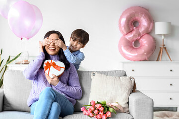 Little son greeting his mother for International Women's day at home