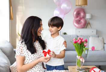 Little son greeting his mother for International Women's day at home