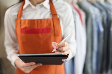 Woman laundry worker makes notes, blurry