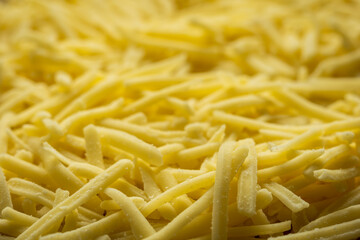 grated cheddar cheese background closeup