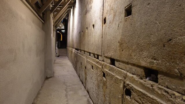 Walking past stones of the Western Wall inside an underground tunnel complex in Jerusalem, Judaism and religion in Israel
