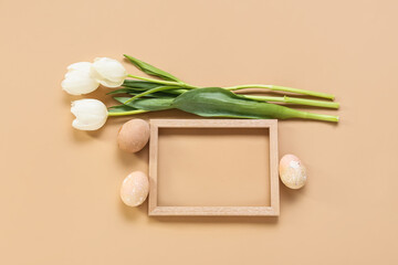 Beautiful composition with frame, Easter eggs and flowers on color background
