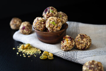 Energy balls of dried fruits and oats on a dark background
