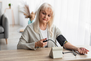 Senior Woman Measuring Blood Pressure at Home