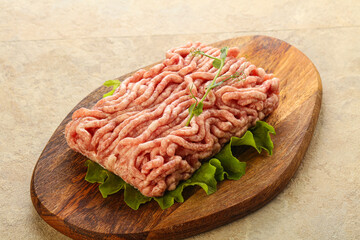 Raw minced pork meat over board