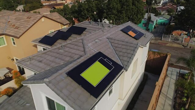 Solar Panels Installed On House Roof On A Sunny Day with Giant Battery Motion Graphics In Los Angeles, California. - aerial flyover