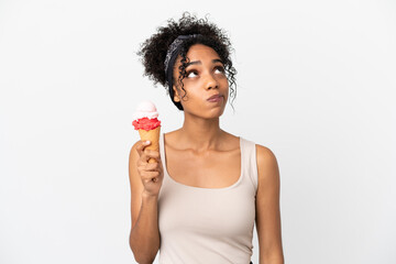 Young african american woman with a cornet ice cream isolated on white background and looking up