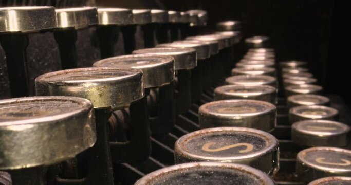 Vintage journalist desk. Vintage typewriter hidden behind book.