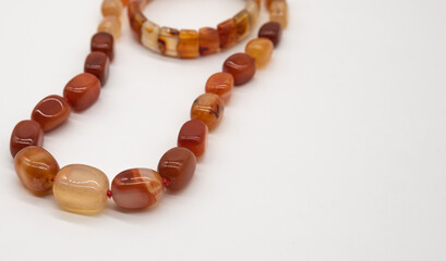 beads and bracelet made of jasper on a white background