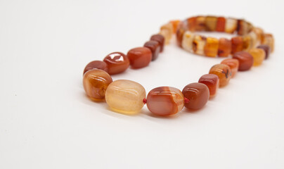 beads and bracelet made of jasper on a white background