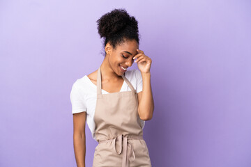 Restaurant waiter latin woman isolated on purple background laughing