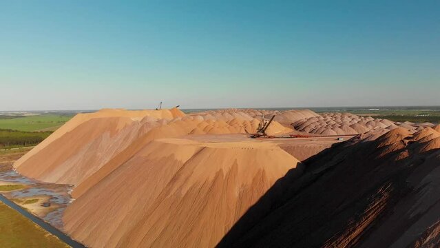 Aerial salt mining mountain of extraction products. Potash salt mining products. Potassium Fertilizers from Soligorsk, Belarus under sanctions. Aerial ascending view.