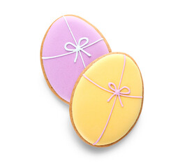 Delicious Easter cookies in shape of eggs with bows on light background