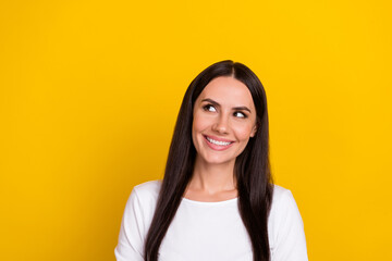 Photo of young cheerful lady curious interested look empty space idea isolated over yellow color background