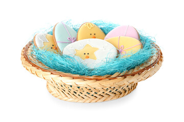 Wicker basket with Easter cookies on light background