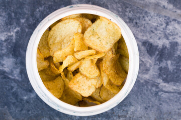 chips in bowl from above on marble background