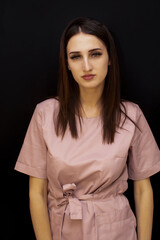 Young beautiful doctor woman wearing medical uniform over isolated background happy face smiling with hands in pockets looking at the camera. Positive person