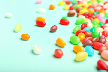 Different jelly beans on color background, closeup