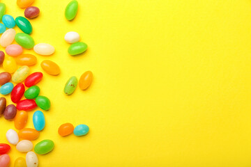 Different jelly beans on yellow background