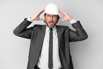 Young architect man with helmet over isolated background with surprise expression