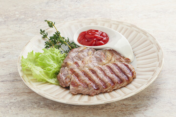 Grilled pork neck steak with ketchup