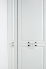 Close-up detail of vintage white cabinet, original ceramic handles, selective focus, copy space