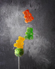 Children's sweets: cake pops and marmalade. Food levitation concept.