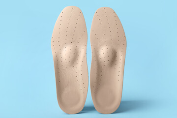 Orthopedic insoles on blue background