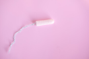 female tampon on a pink background. Hygienic white tampon for women.