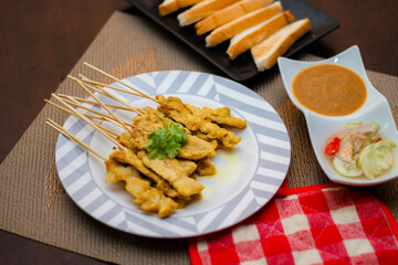 Pork satay - Grilled pork served with peanut sauce or sweet,sour sauce and toast,  Thai street food and delicious food in the restaurant.