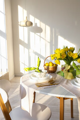 Beautiful table setting for Easter celebration on table in light room