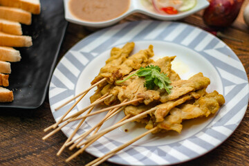 Pork satay - Grilled pork served with peanut sauce or sweet,sour sauce and toast,  Thai street food and delicious food in the restaurant.
