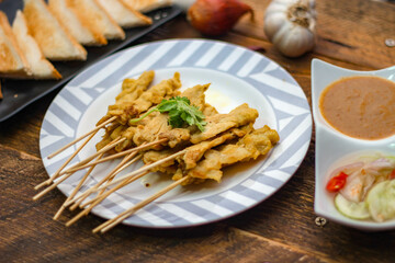 Pork satay - Grilled pork served with peanut sauce or sweet,sour sauce and toast,  Thai street food and delicious food in the restaurant.