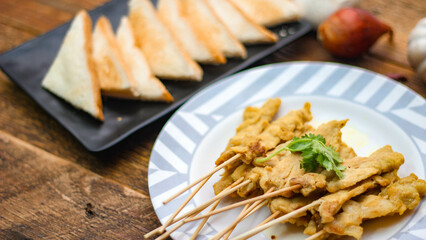 Pork satay - Grilled pork served with peanut sauce or sweet,sour sauce and toast,  Thai street food and delicious food in the restaurant.