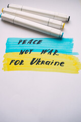 drawing with markers with the flag of Ukraine peace, not war for Ukraine. Pray for Ukraine 