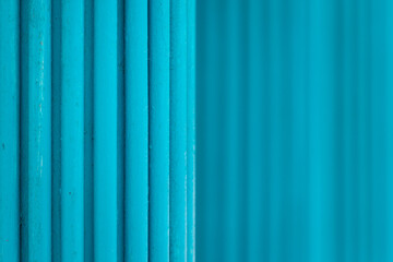 Many vertical pipes in turquoise color in perspective. Selective focus. abstract background