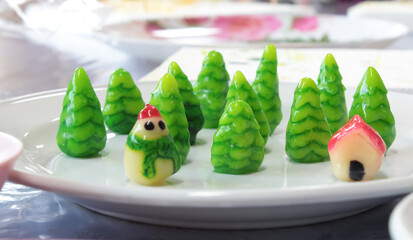 Luk Chub, a Thai dessert made from bean paste and agar adapted from Portuguese dessert macipan, molded into the shape of a pine tree. house and snowman - obrazy, fototapety, plakaty