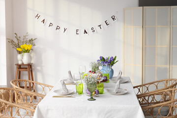 Beautiful table setting with flowers for Easter celebration