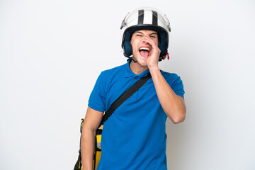 Young caucasian man with thermal backpack isolated on white background shouting with mouth wide open