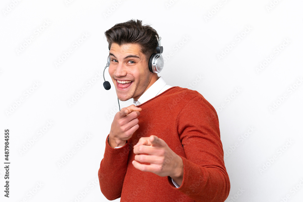 Wall mural telemarketer caucasian man working with a headset isolated on white background pointing to the front