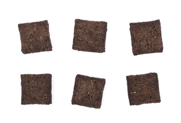 Cereal flakes in form of pillows, with vanilla flavor, pile isolated on white