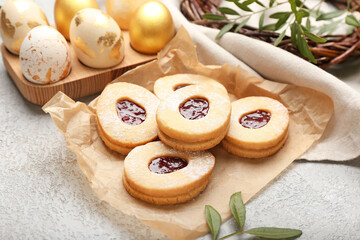 Tasty cookies in shape of eggs on light background