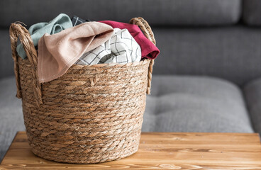 Household chores around the house. Washing clothes. A wicker basket with dirty laundry in the room...