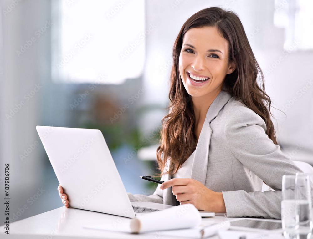 Wall mural Shes made it. Shot of an attractive businesswoman sitting at her desk in an office.