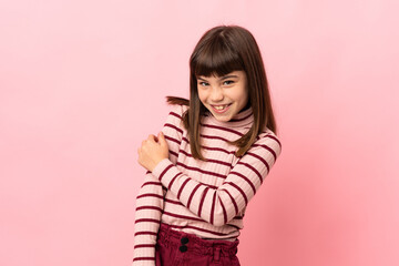 Little girl isolated on pink background laughing