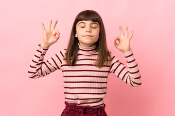 Little girl isolated on pink background in zen pose