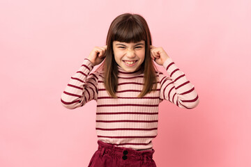 Little girl isolated on pink background frustrated and covering ears