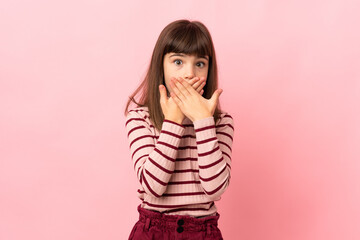 Little girl isolated on pink background covering mouth with hands